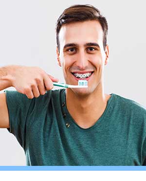 Caring for Braces interior photo man brushing San Marcos Orthodontics San Marcos CA